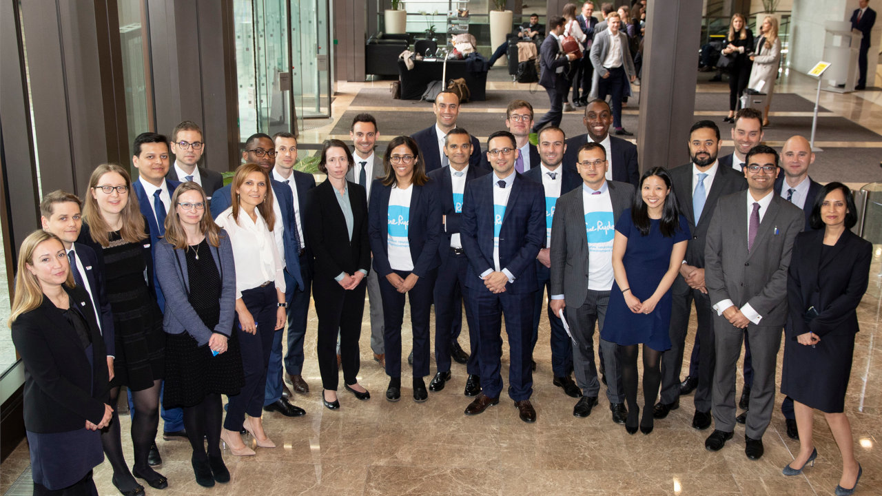 A group of Morgan Stanley employees in an office space looking up to the camera