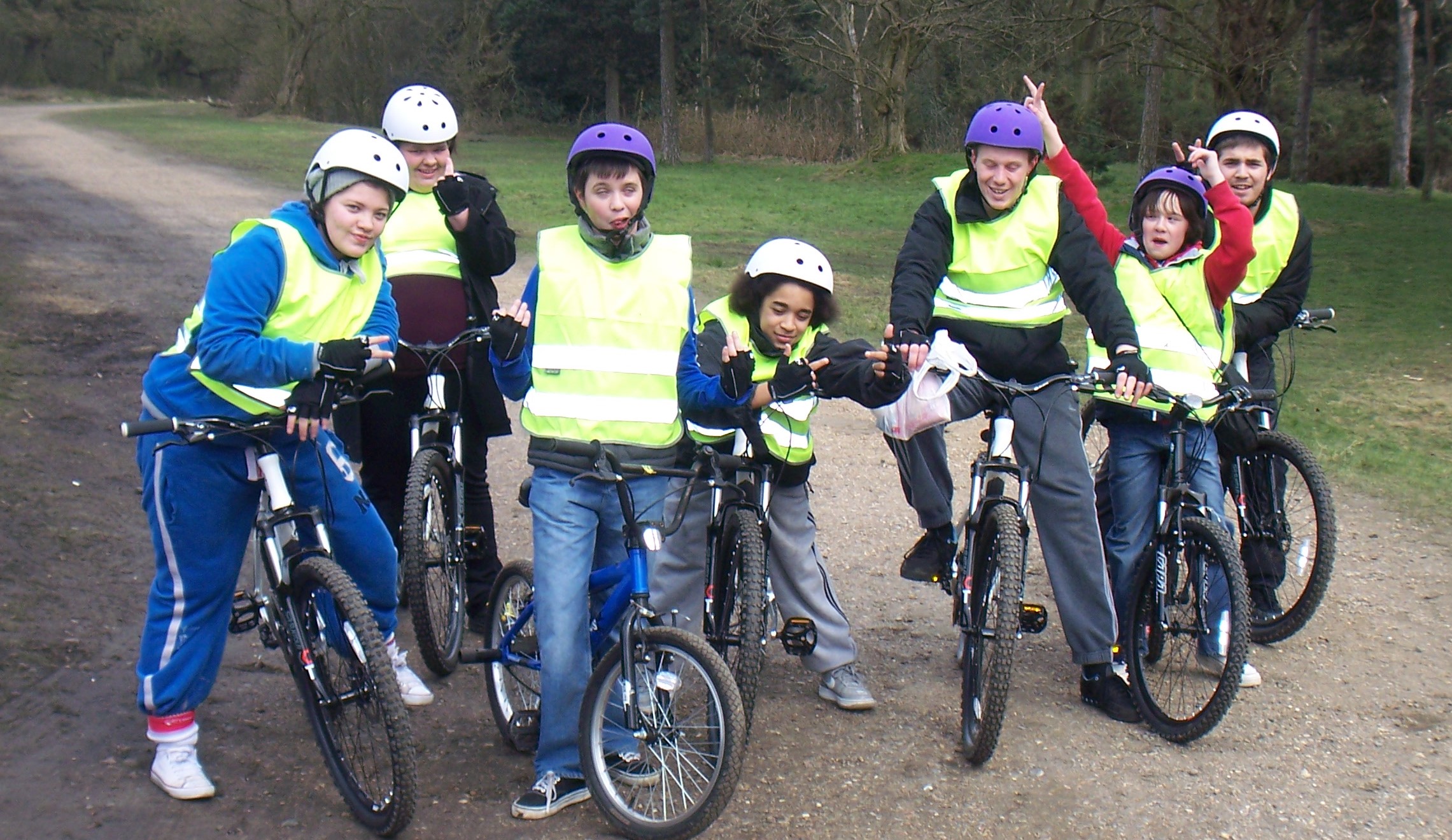 A group of children posing on their bicycles