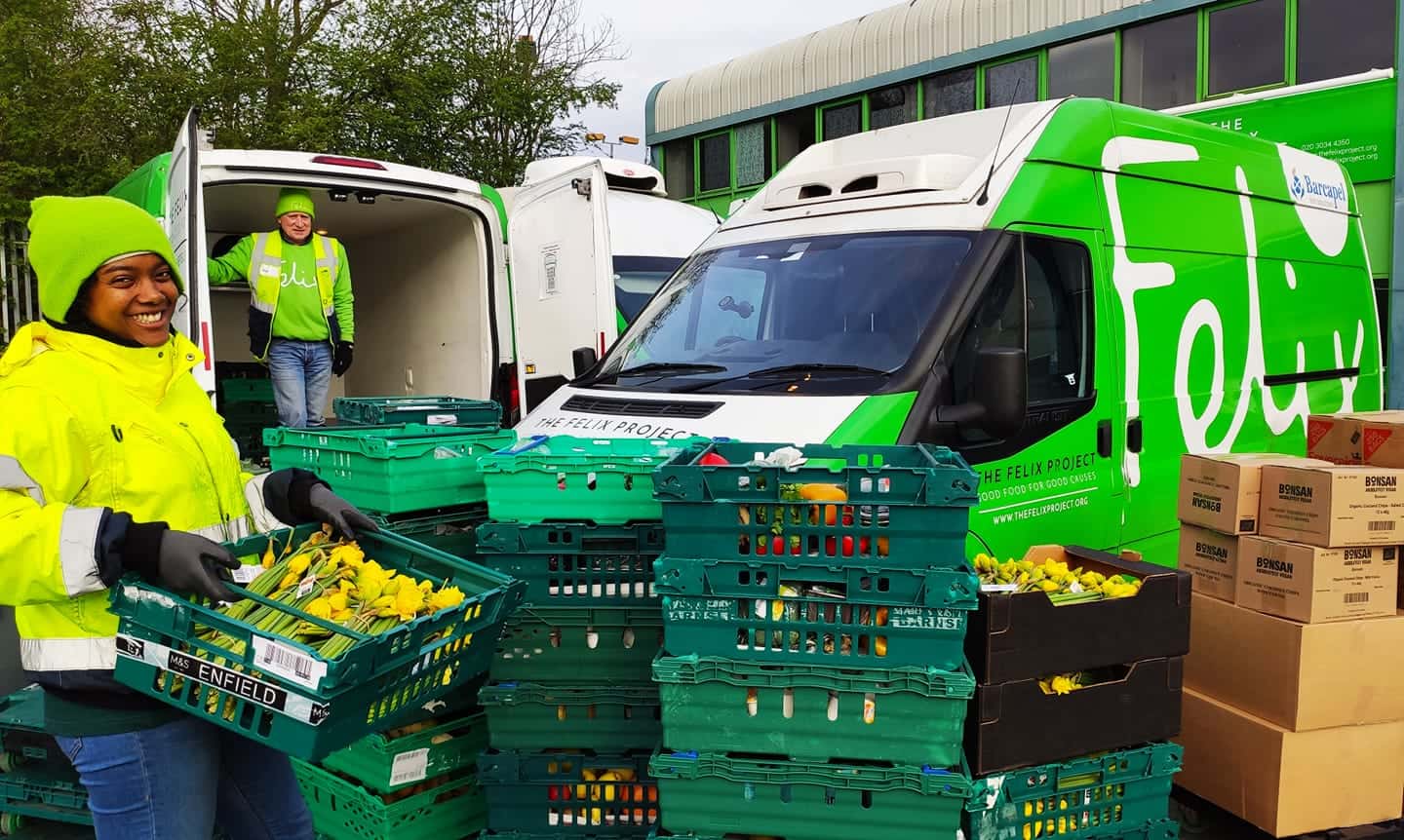 Two people loading food into vans