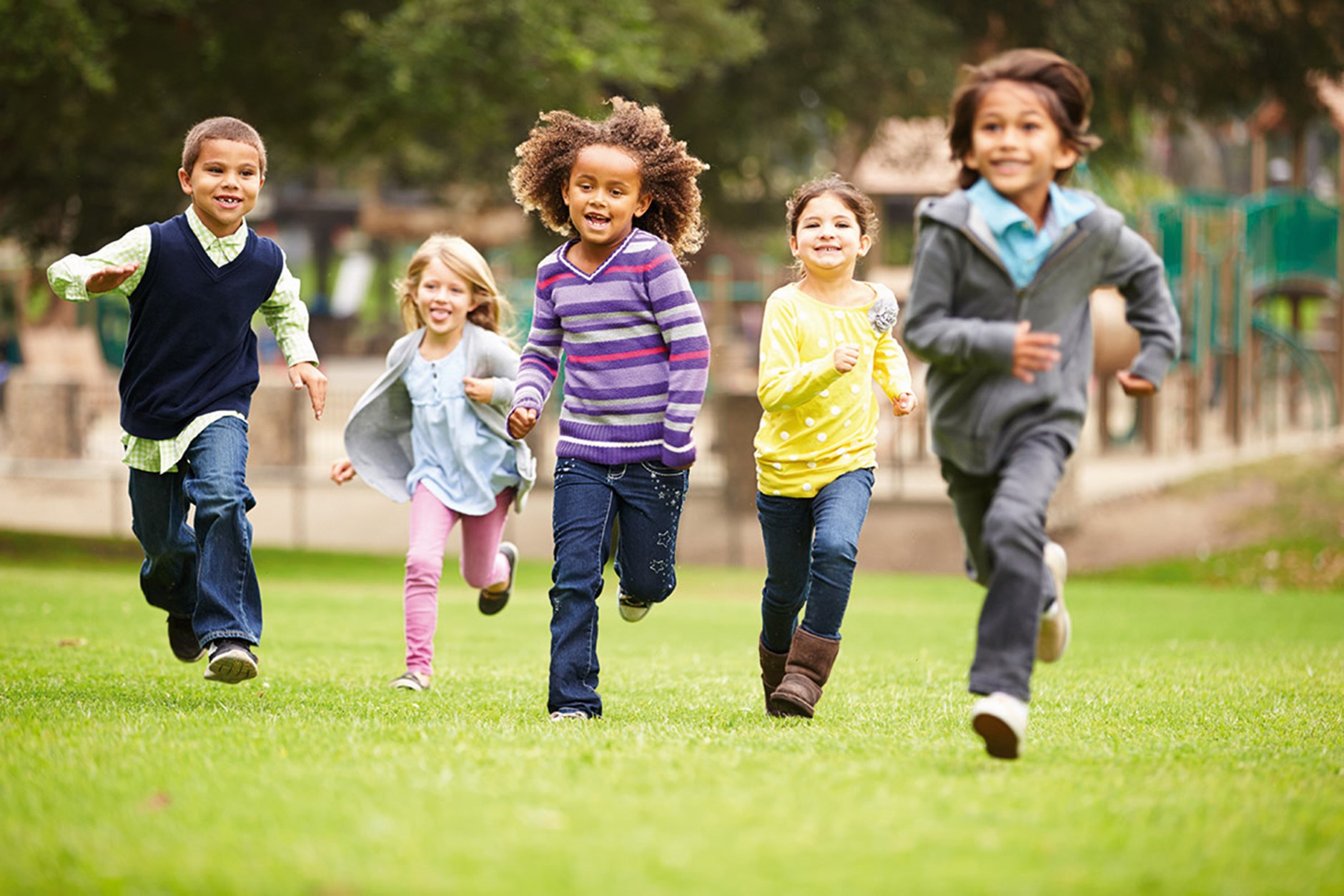 A group of children running towards the camera