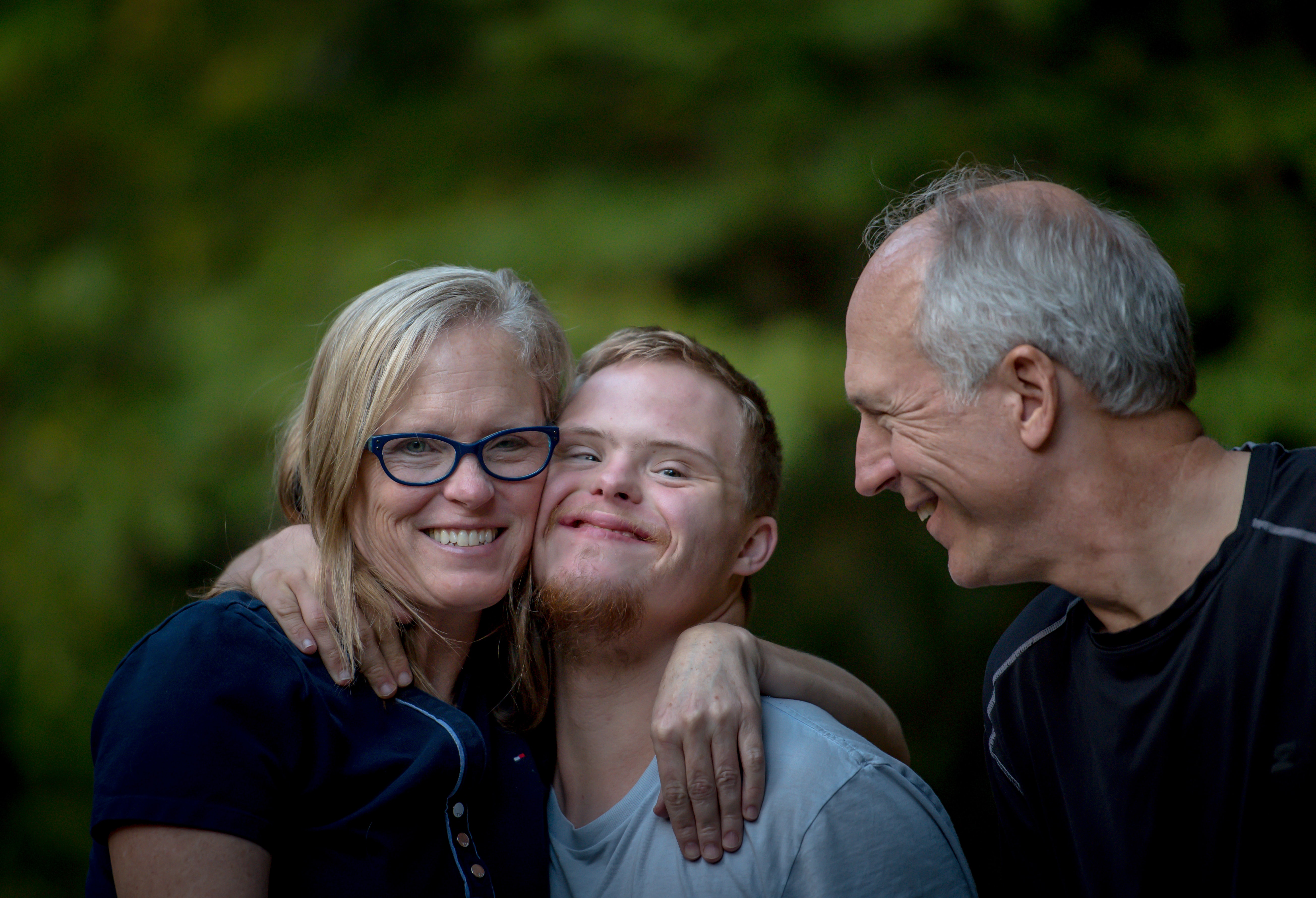 Two parents with their son who has disabilities