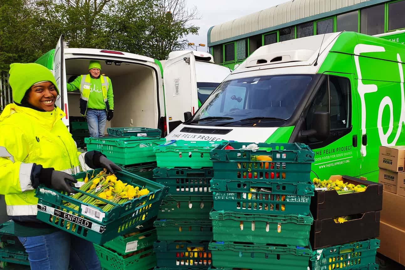 Two people filling vans with food