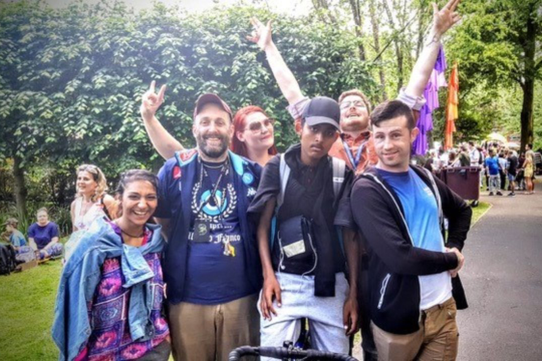A group of people around a bicycle in a park