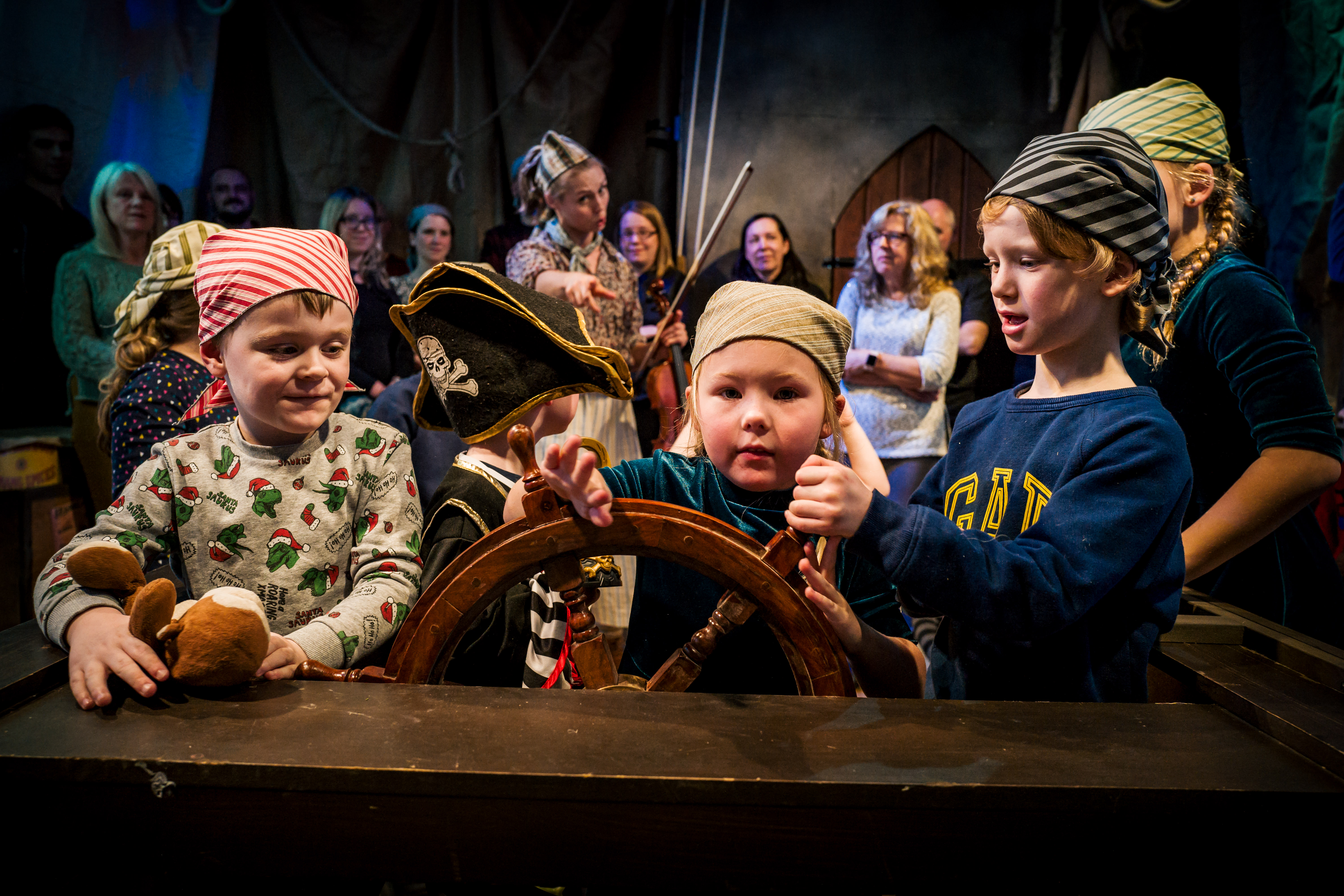 A group of children on stage dressed as pirates