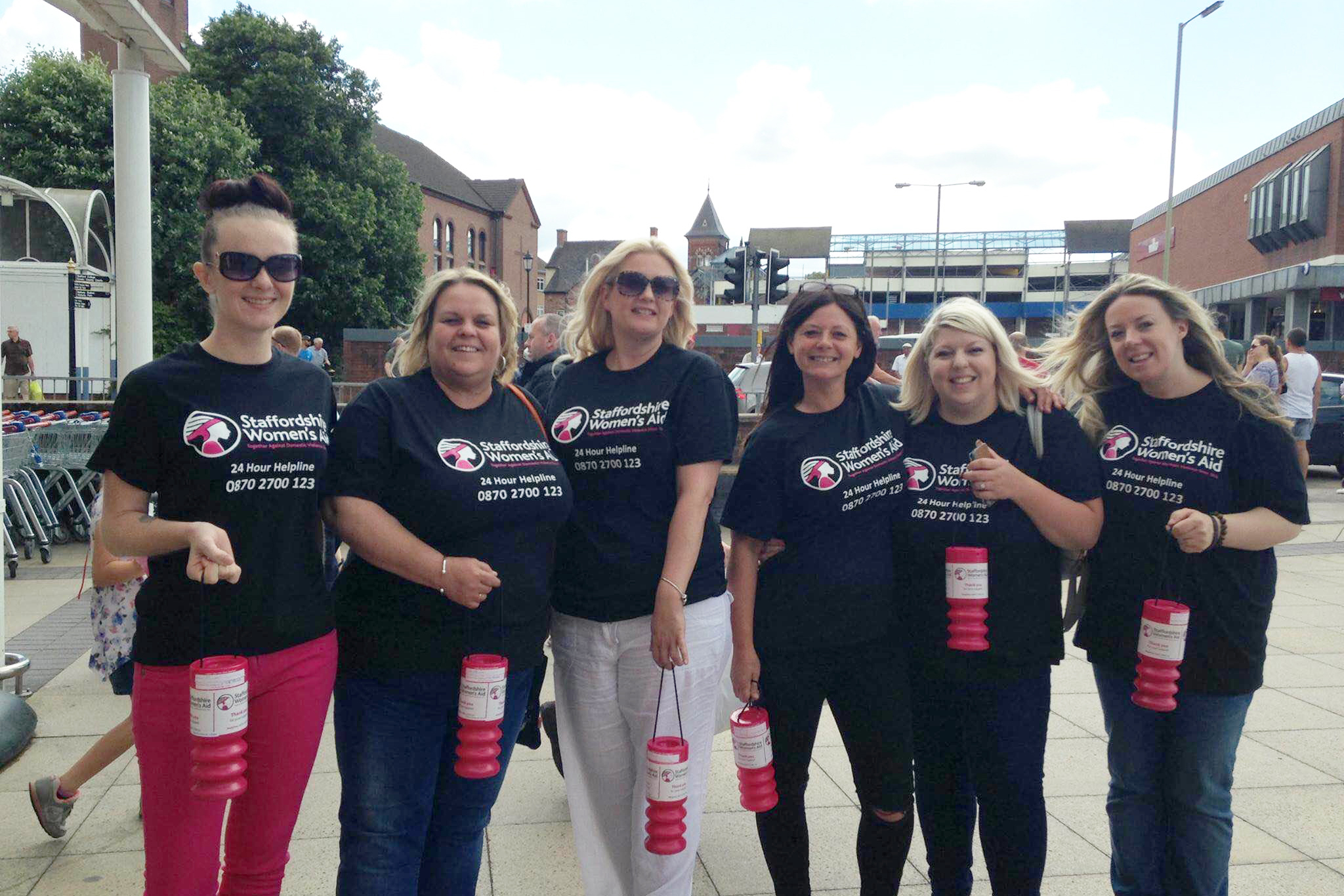 A group of women with donation tins