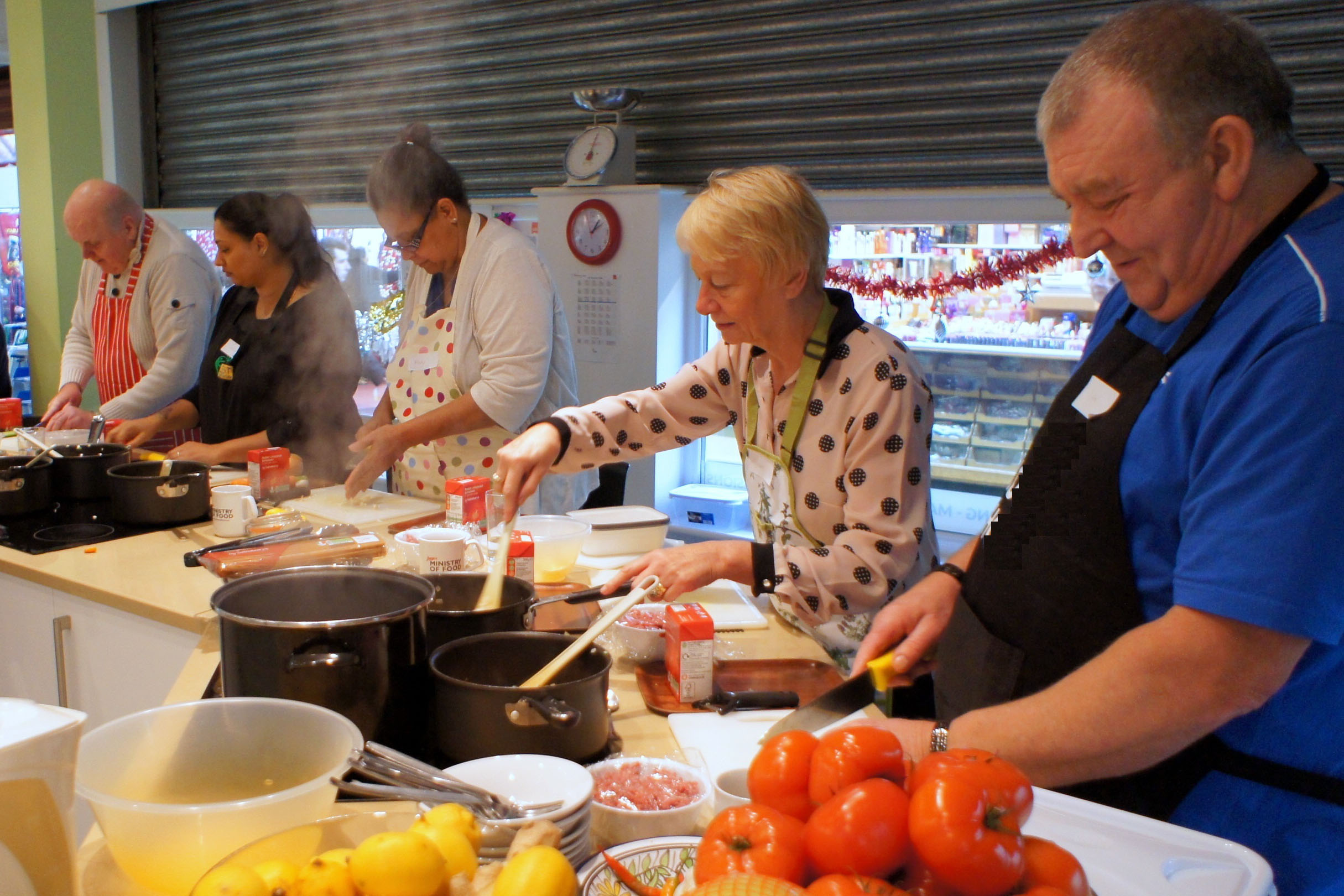 Five people preparing food in a canteen