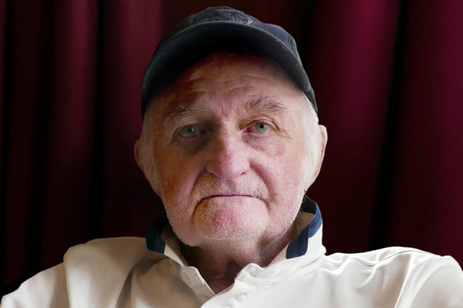 A man in a cap looking at the camera