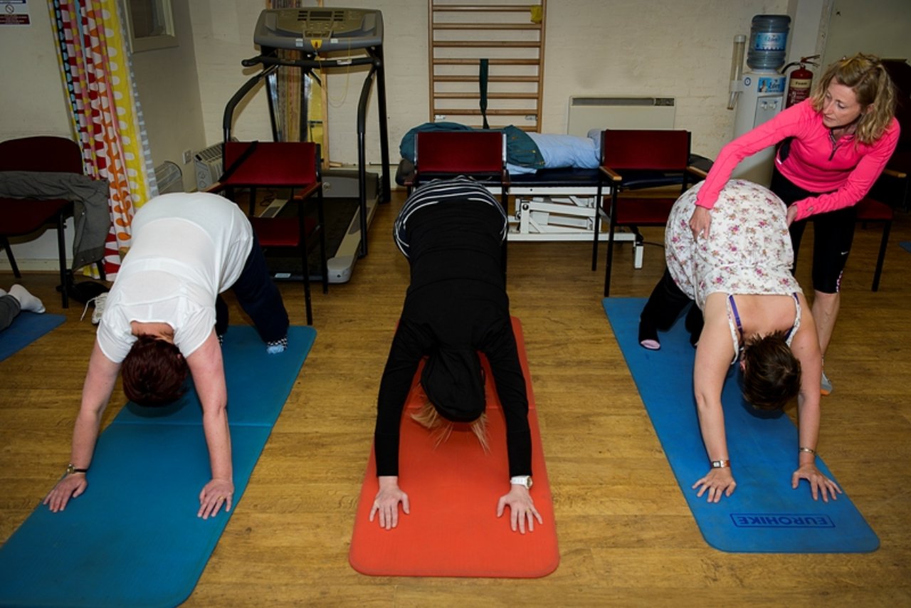 Three people doing yoga