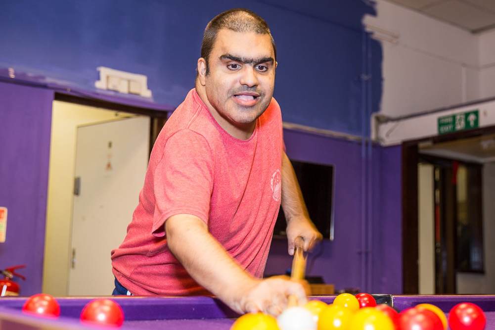 Asian man playing pool