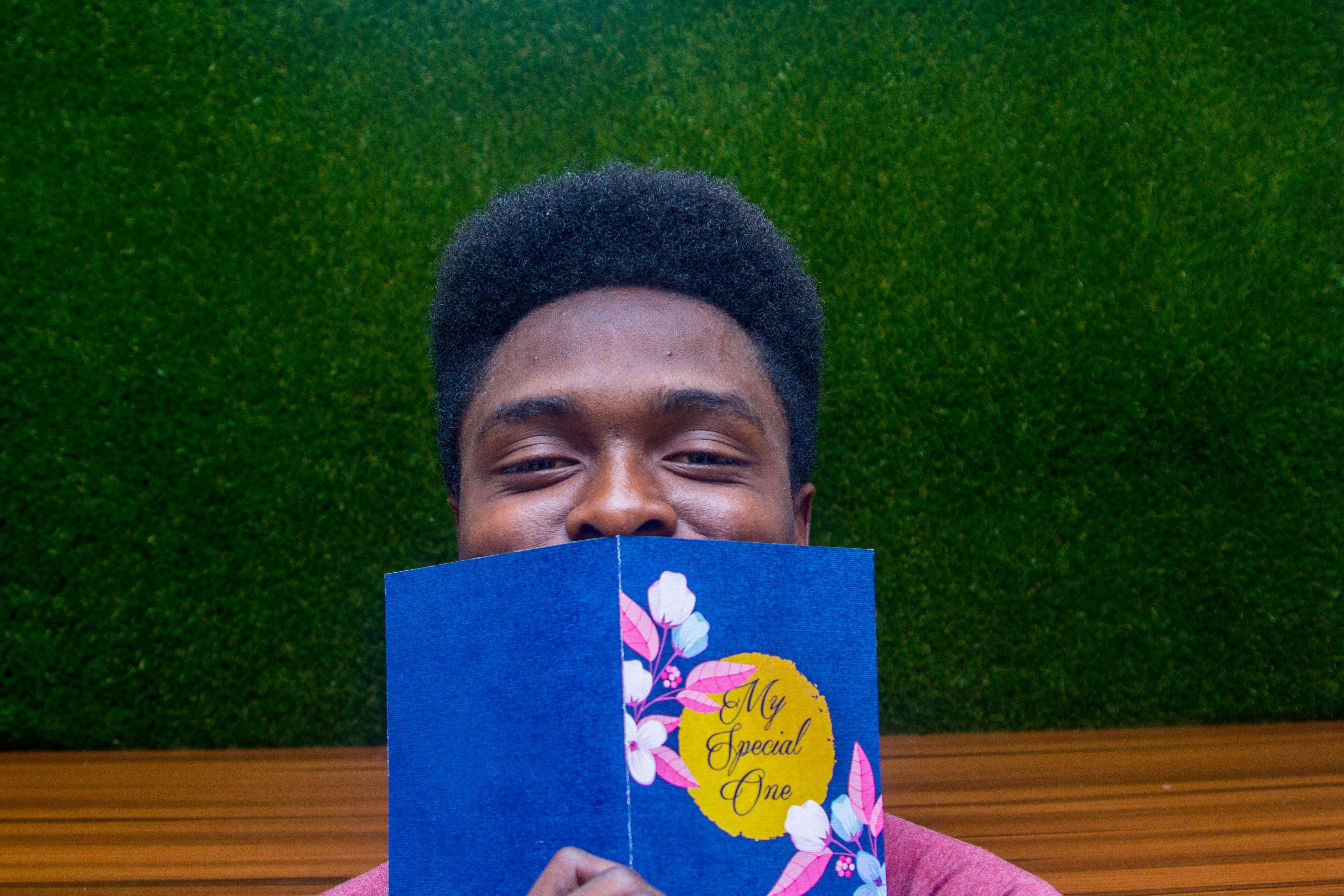 Black man reading a card