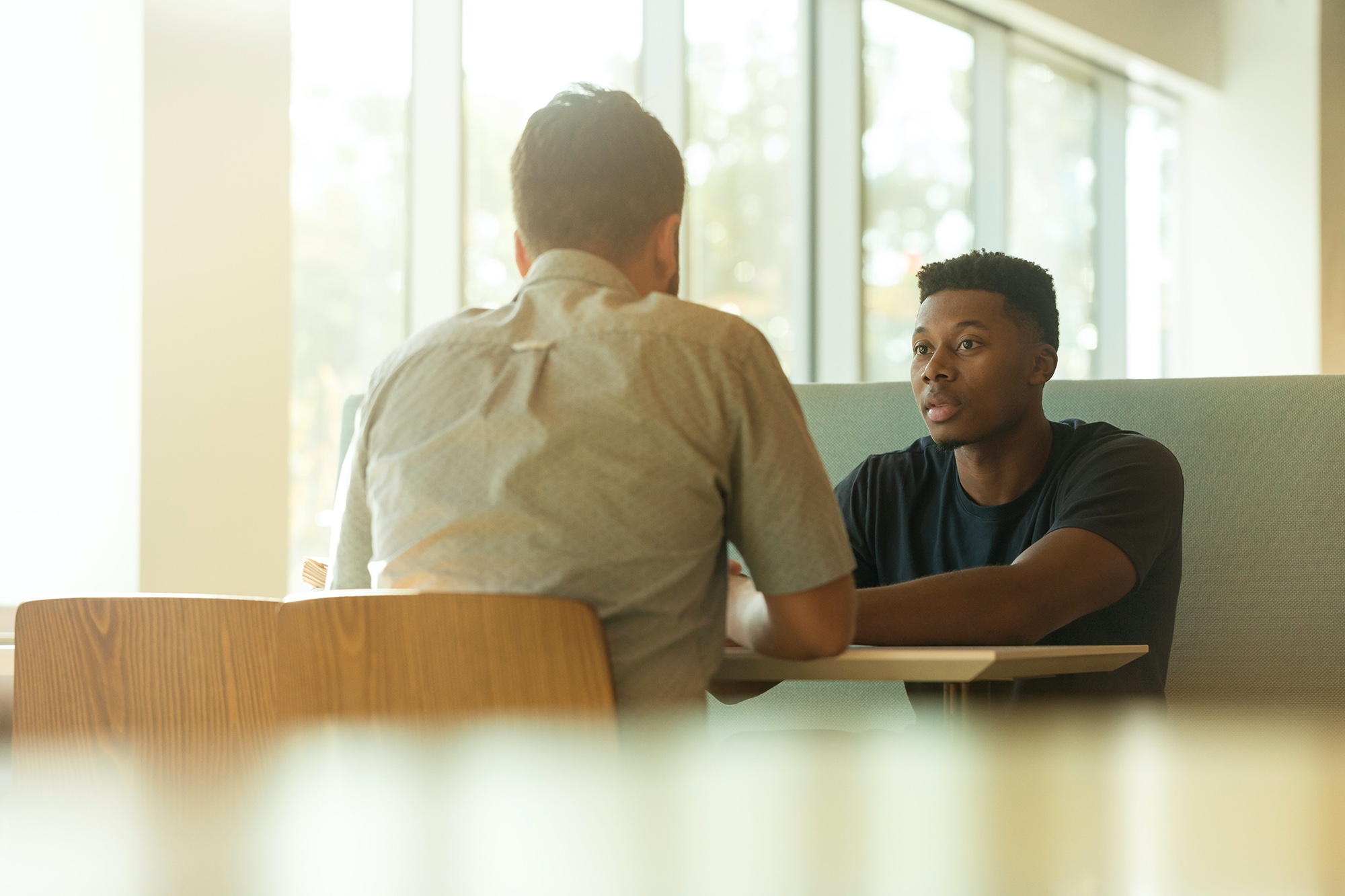 Two people sitting and talking