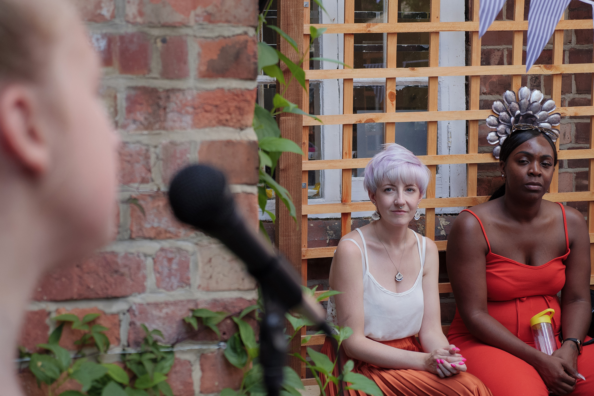 A person singing to two other people