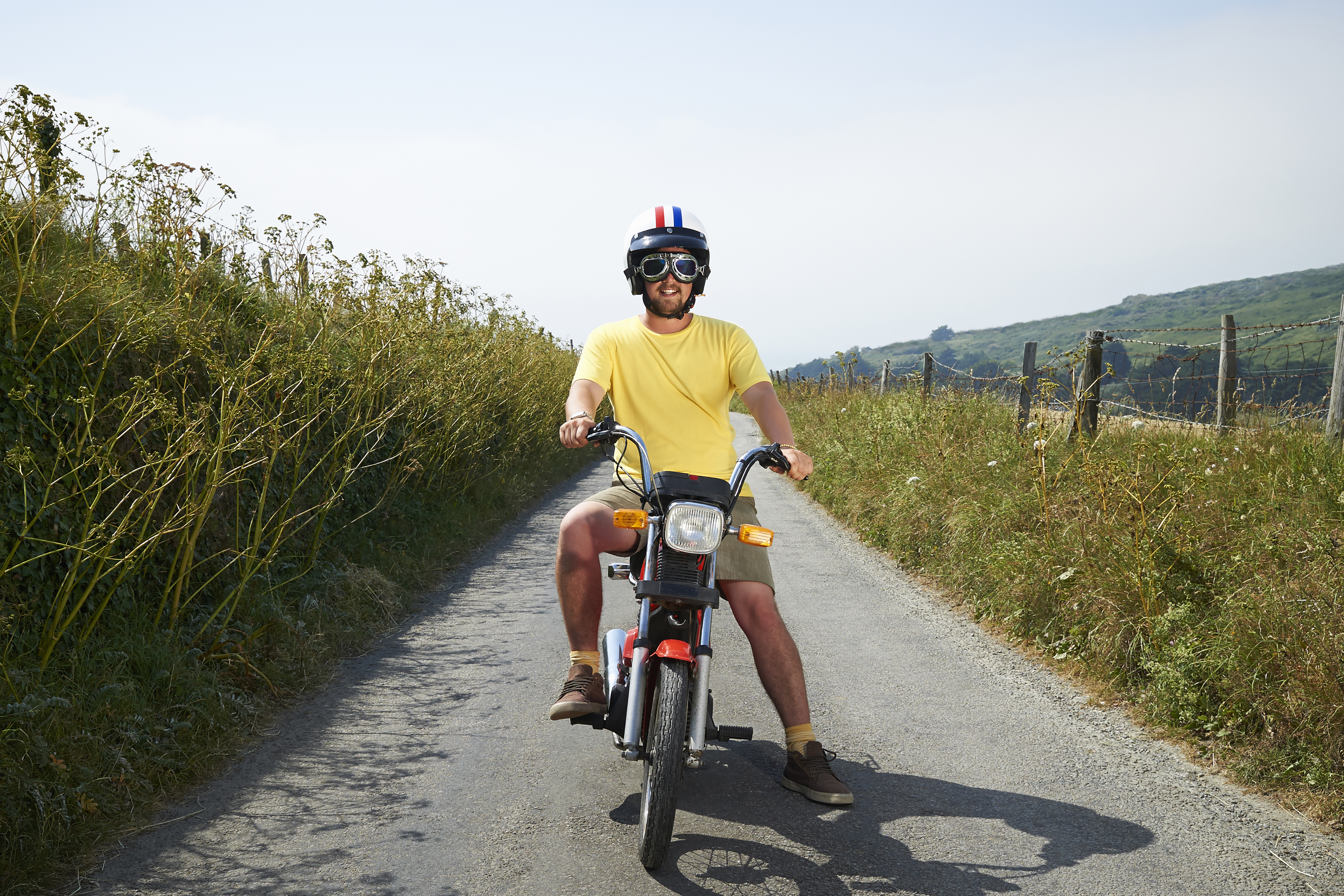 A man in yellow on a motorbike