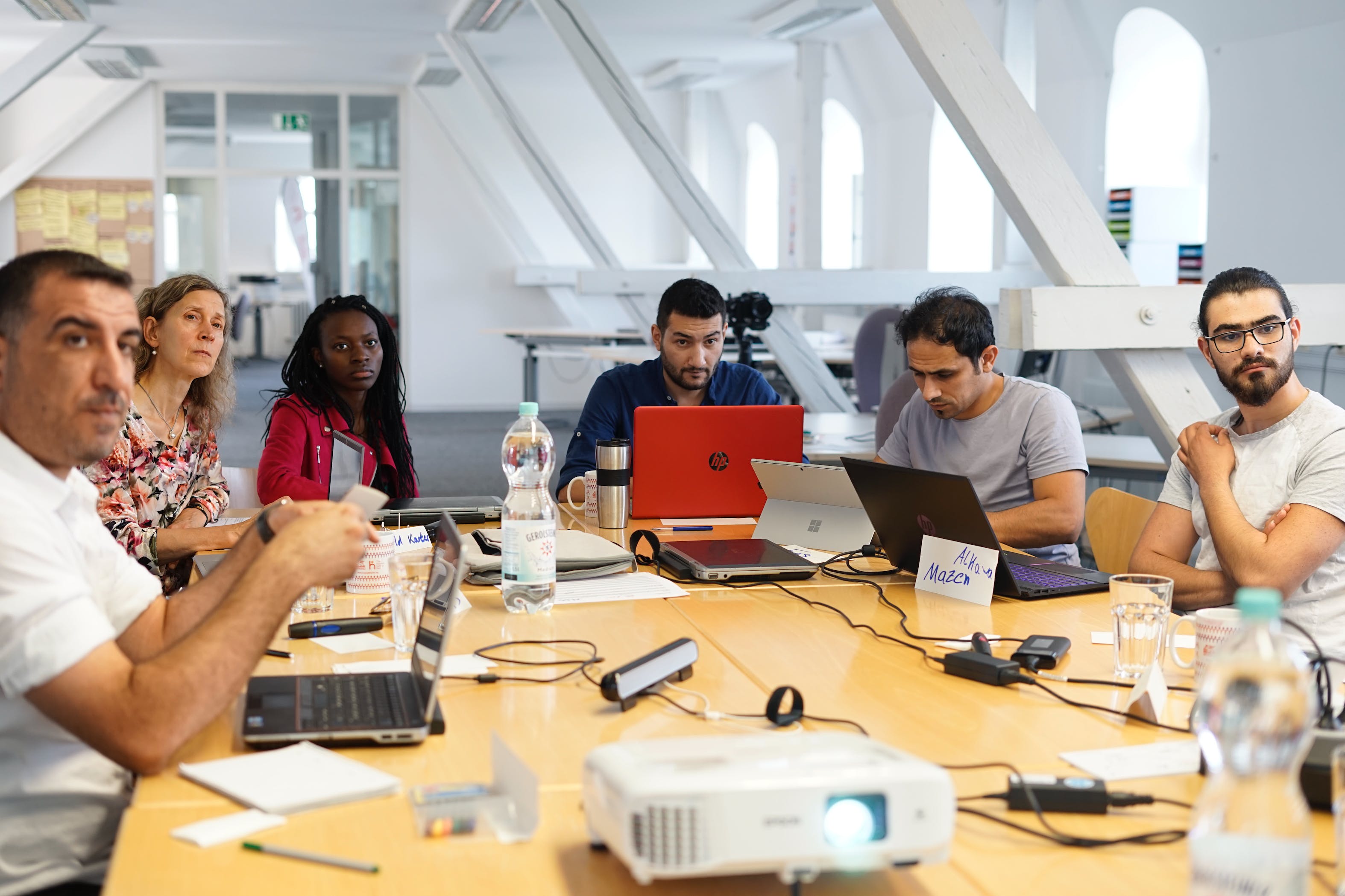 A group of people at a desk in a workshop