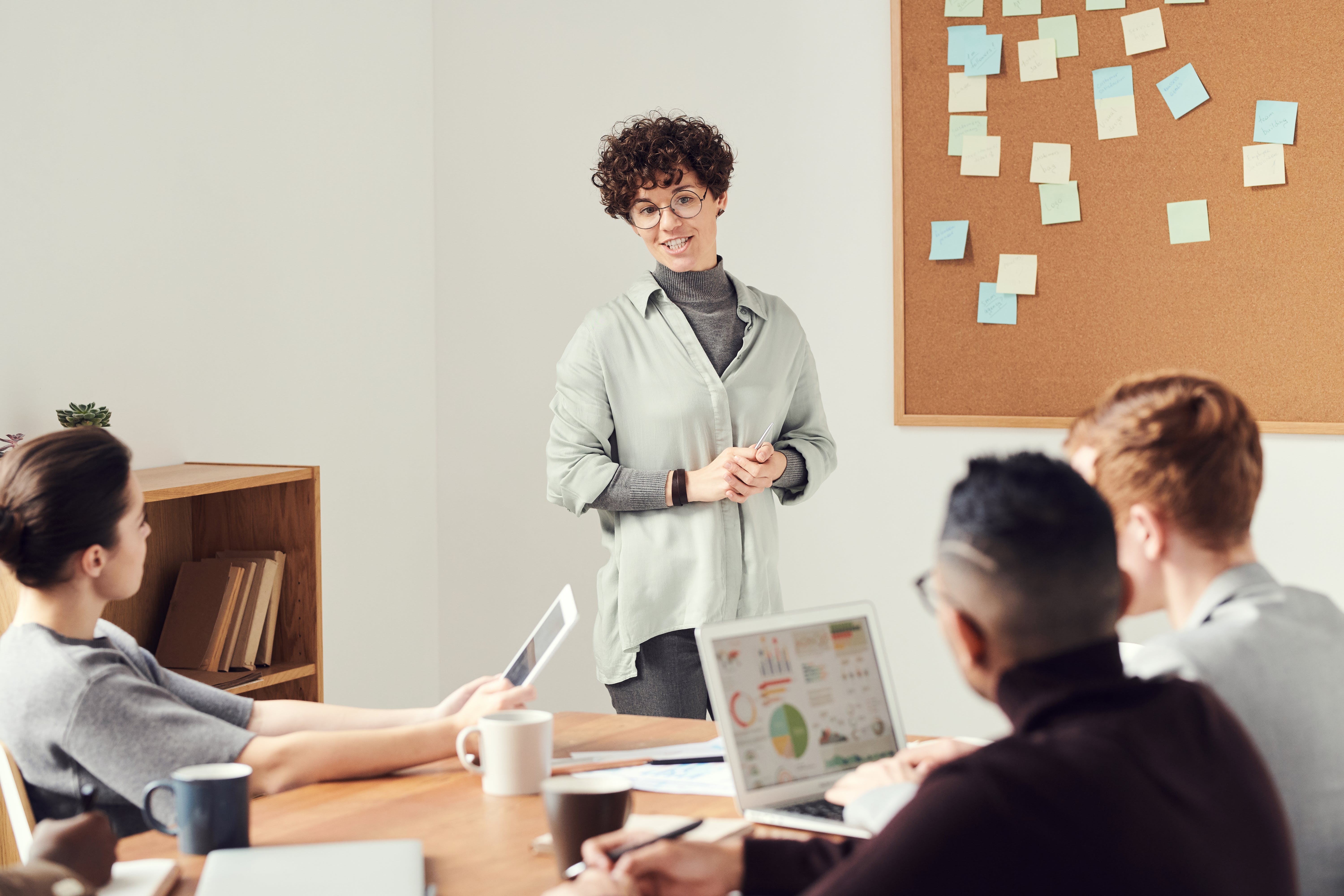 Person presenting with sticky notes on a cork board