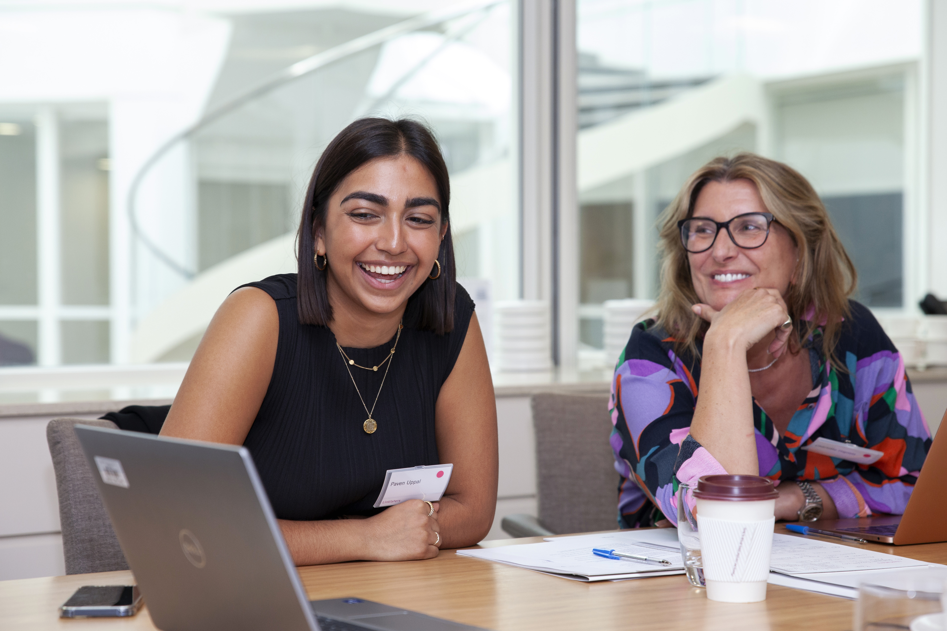 Two people looking at a laptop happy