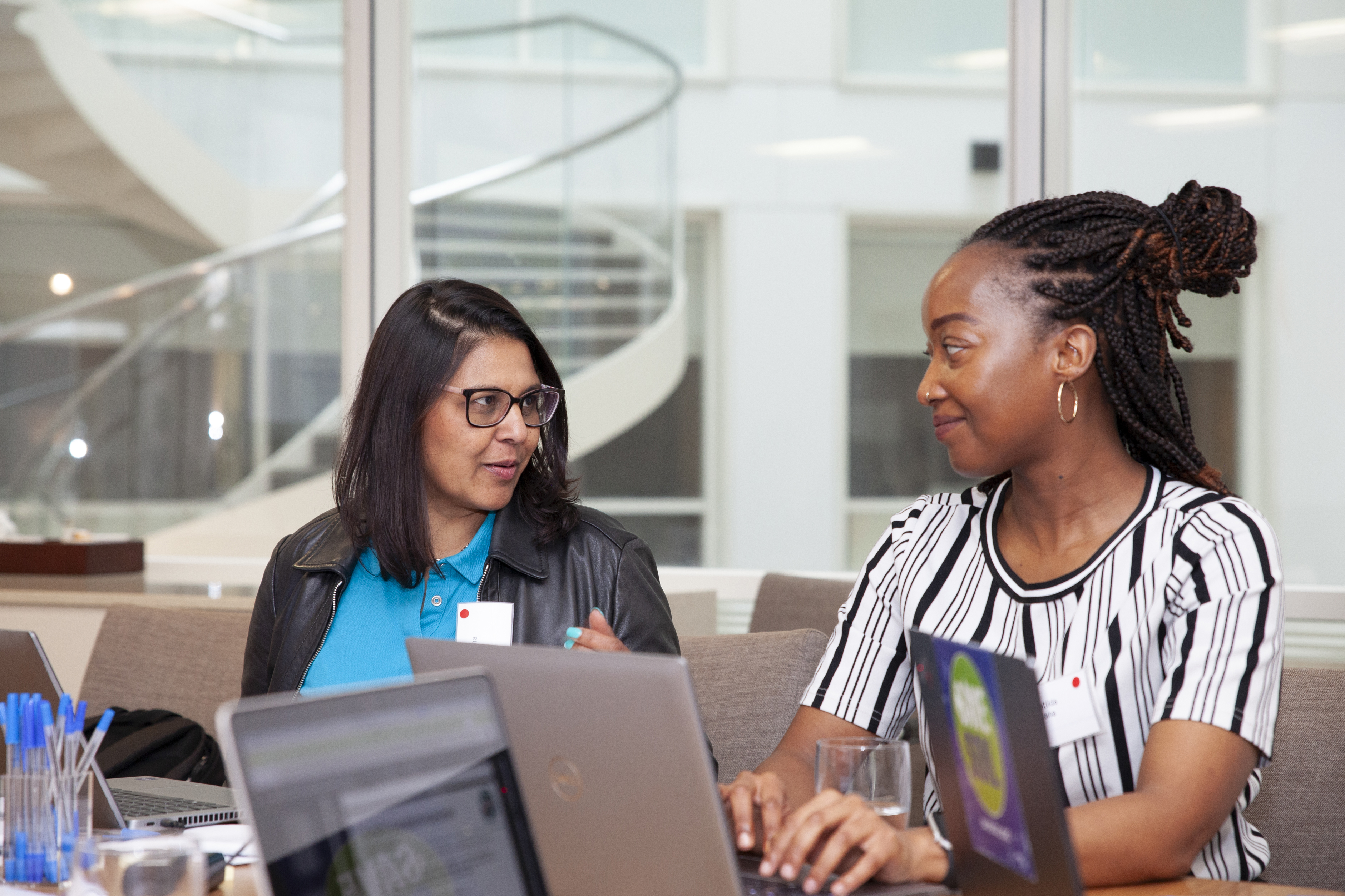 Two women of the global majority looking at each other