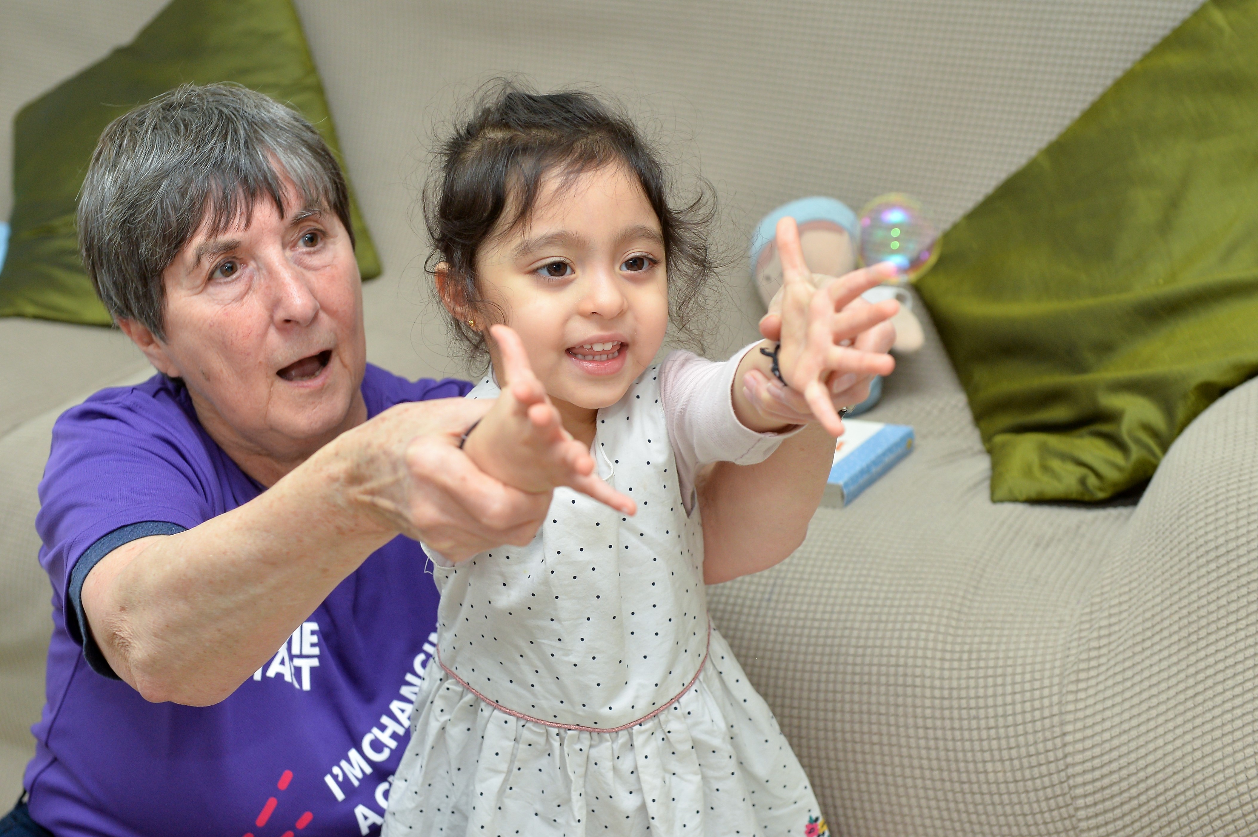 Adult helps a child reach out