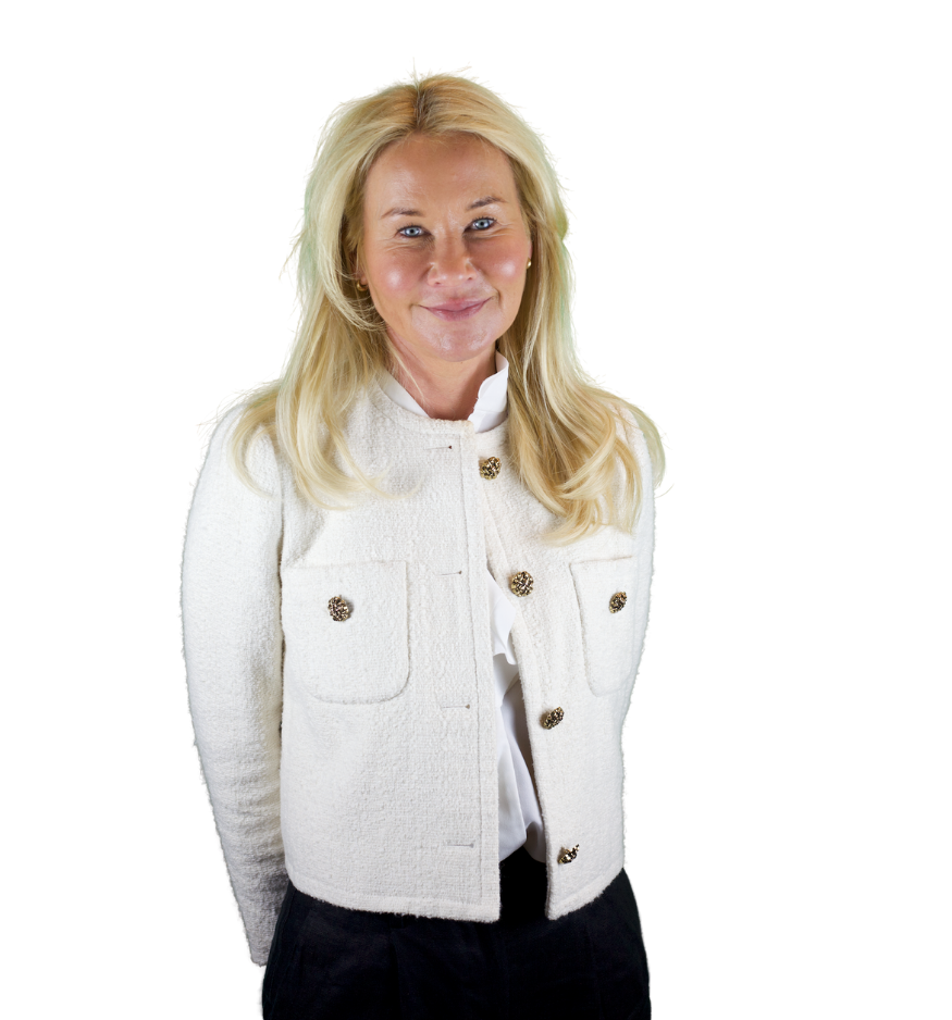 Trustee Anna Moulton wears a white denim jacket and smiles at the camera