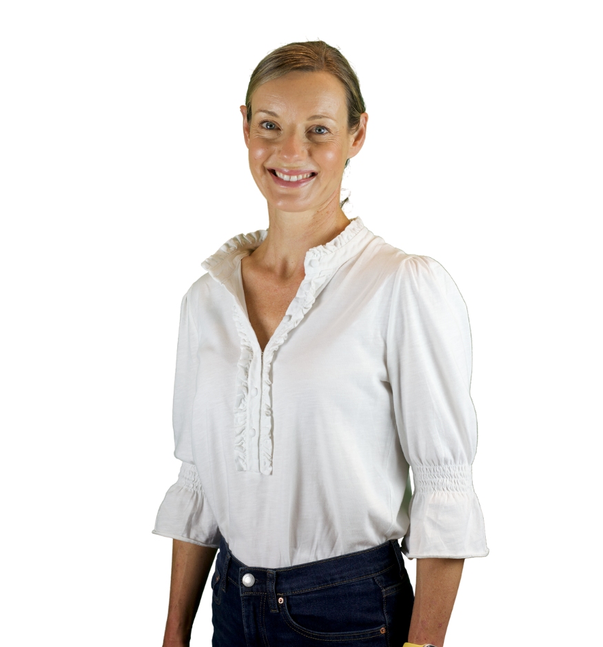 Trustee Kate Cramer wears a white blouse and smiles at the camera.